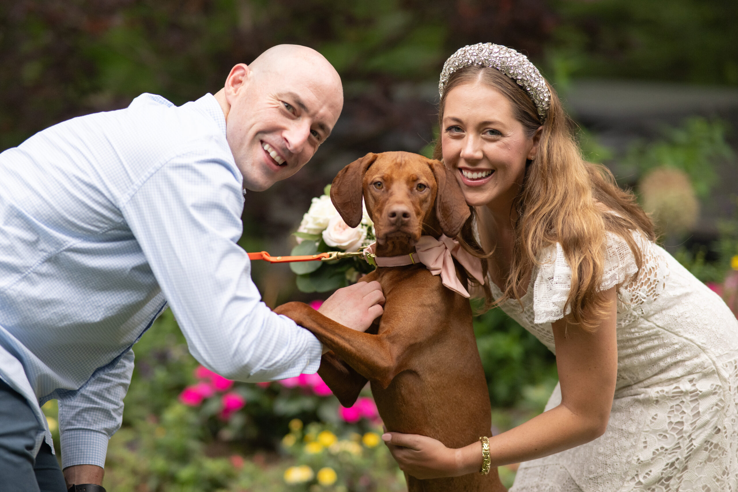 brendan and his wife with their dog on their wedding day
